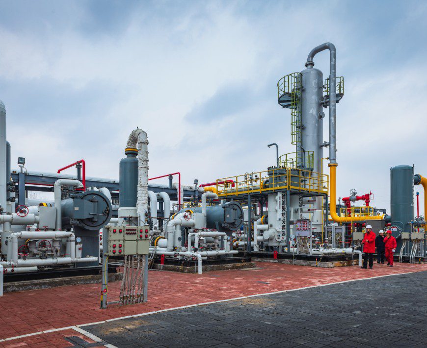 Workers inspecting gas plant equipment